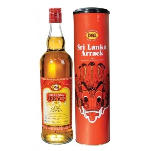 A bottle of Sri Lankan Arrack is shown next to a decorative red cylindrical gift box. The bottle has a red cap and a red and yellow label that says "Sri Lanka Arrack" and "Pure Coconut Arrack". The gift box is red with black text and features a traditional Sri Lankan mask design.